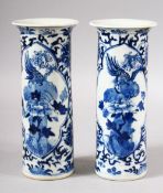 A PAIR OF CHINESE BLUE AND WHITE PORCELAIN SLEEVE VASES, painted with panels depicting a bird