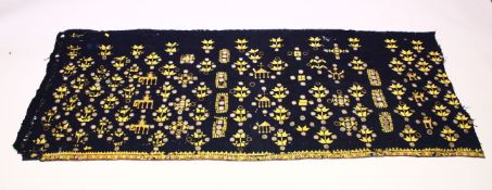 AN INDIAN SUZANI EMBROIDERD TEXTILE, with mirrored roundels, 180cm x 73cm.