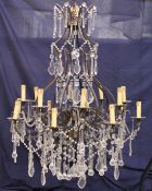 A GOOD LARGE WROUGHT IRON AND CUT GLASS CHANDELIER.