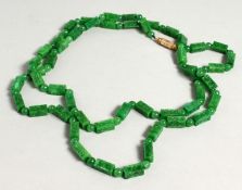 A LONG GREEN JADE NECKLACE CARVED RECTANGULAR BEADS 44ins long