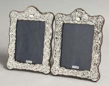 A PAIR OF SILVER REPOUSSE PHOTOGRAPH FRAMES 7.5ins x5ins