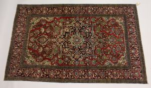 A PERSIAN ISFAHAN RUG, red and blue ground with all over floral decoration 7ft 5ins x 4ft 8inS.
