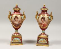 A VERY GOOD PAIR OF 19TH CENTURY VIENNA PORCELAIN TWO HANDLED URNS AND COVERS painted with portraits