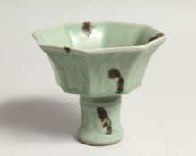A CHINESE GREEN STEM CUP octagonal on a circular base.