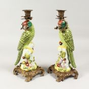 A PAIR OF PORCELAIN AND METAL CANDLESTICKS 14ins high