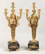 A GOOD PAIR OF EMPIRE DESIGN BRONZE AND MARBLE EGYPTIAN DESIGN THREE BRANCH CANDLESTICKS on a marble