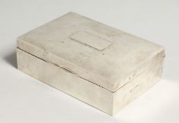 A PLAIN SILVER CIGARETTE BOX 6 ins long, London 1904
