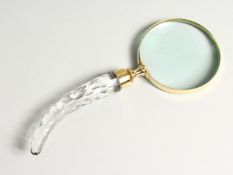 A MAGNIFYING GLASS with a cut glass handle.