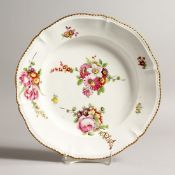 AN 18TH CENTURY CONTINENTAL CIRCULAR DISH painted with flowers 11ins diameter.