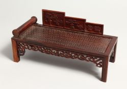 A CHINESE MINIATURE WOODEN DAY BED 9ins long