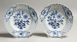 A PAIR OF MEISSEN BLUE AND WHITE PORCELAIN PLATES, with pierced latticework borders. 8ins diameter.
