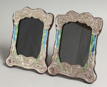 A PAIR OF SILVER AND ENAMEL BUTTERFLY PHOTOGRAPH FRAMES 8ins x 5.5ins