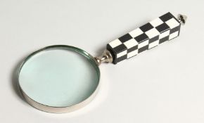 A MAGNIFYING GLASS with a chequered handle.