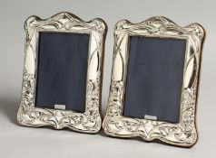 A PAIR OF SILVER ART NOUVEAU DESIGN PHOTOGRAPH FRAMES 7.5 x 5ins