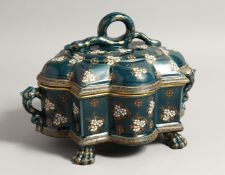 AN UNUSUAL GREEN GLAZED POTTERY TUREEN AND COVER, enamel decorated with stylised flowers with
