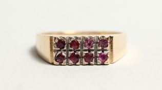 A GOLD AND TWO ROW RUBY RING.
