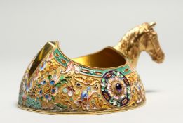 A GOOD RUSSIAN SILVER GILT AND ENAMEL KOVSH with horses head handle, 5ins long, mark Russian Eagle