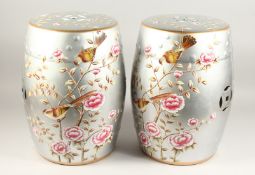 A PAIR OF CHINESE SILVER BARREL SEATS with birds 18ins high.