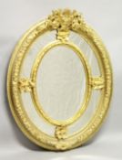 A GOOD LARGE DECORATIVE OVAL WALL MIRROR, with ornate cresting and floral decorated frame. 4ft