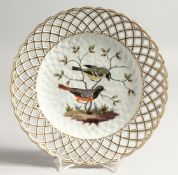 A 19TH CENTURY MEISSEN PIERCED BORDER CIRCULAR PLATE, painted with birds Cross swords mark in