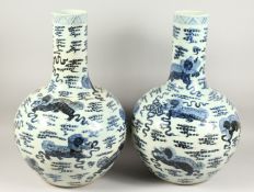 A PAIR OF CHINESE BLUE AND WHITE BULBOUS VASES with long necks 24ins high.
