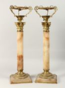 A GOOD PAIR OF 19TH CENTURY ALABASTER CORINTHIAN COLUMN LAMPS on signed bases. 23ins long.