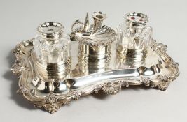 A SUPERB WILLIAM IV SILVER INKWELL with two silver glass bottles and shell shaped chamber stick.