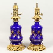 A PAIR OF 19TH CENTURY FRENCH BLUE GLASS AND ORMOLU LAMPS decorated with fruiting vines