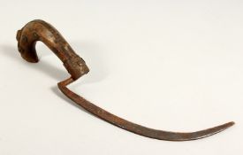 A SMALL RUSTIC KNIFE OR SICKLE 12.5ins high.