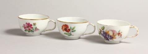 THREE 19TH CENTURY BERLIN CUPS painted with flowers. Septre mark in blue.