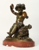 A VERY GOOD BRONZE OF A CHERUB holding cymbals draped in fruiting vines on an oval marble base