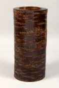 AN UNUSUAL CYLINDRICAL TREE BARK VASE. 12ins high.