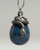 A SMALL RUSSIAN SILVER AND LAPIS EGG PENDANT with curling snake.