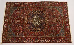A PERSIAN BAKHTIYAR RUG, red ground with all over floral decoration. 6ft 11ins x 4ft 7ins.
