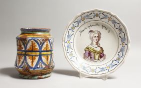 A 19TH CENTURY MAJOLICA DRY DRUG JAR, of wasted form, together with a portrait plate 