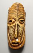 A CARVED BONE MASK, possibly LEGA 8ins x 3ins