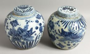 A PAIR OF CHINESE BLUE AND WHITE GINGER JARS AND COVERS with fish. 12ins high.