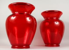 A PAIR OF MOULDED RED PLASTIC VASES/STANDS 