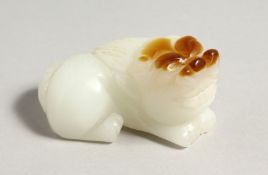 A CHINESE CARVED WHITE JADE DOG OF FOU. 3ins long