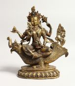 A GILT BRONZE DEITY OF A DRAGON inset with hardstones. 10ins high.