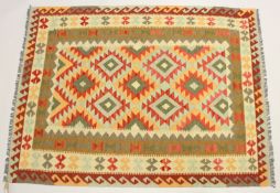 A CAUCASIAN DESIGN KEILIM CARPET of typical form with geometric decoration. 6ft 8ins x 5ft.