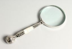 A MAGNIFYING GLASS with a marble and chrome handle.