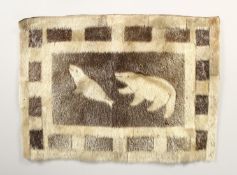 AN INUIT SEALSKIN WALL HANGING, depicting a polar bear hunting a seal. 21.5ins x 15.5ins.