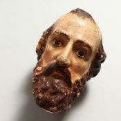 A PAINTED TERRACOTTA HEAD OF A SAINT 4.5ins high.