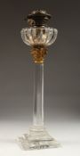 A GOOD VICTORIAN GLASS OIL LAMP on a stamped square base. 23ins high.