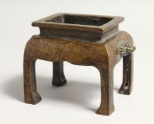 A GILT BRONZE RECTANGULAR CENSER on legs 5ins long