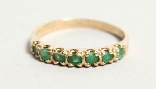 A GOLD EMERALD SET RING