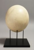 AN OSTRICH EGG, on metal stand. 8.5ins high.