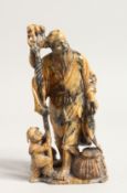 A CARVED SOPASTONE FIGURE OF A MAN AND BOY. 6ins high.