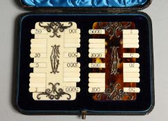 TWO IVORY AND TORTOISESHELL BRIDGE MARKERS in a leather case.